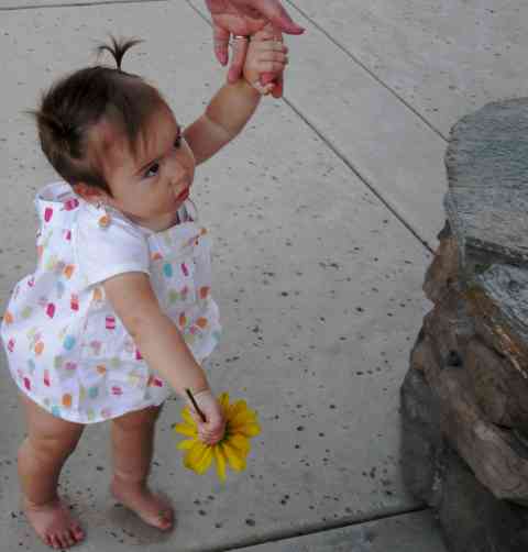 Holding a hand & a flower while walking