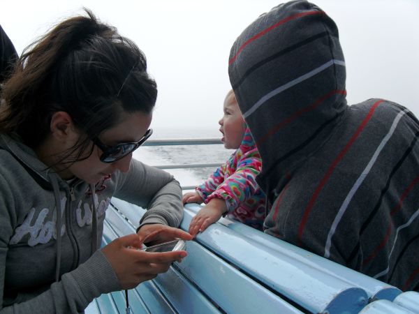 I look out to sea while Mom checks her cell